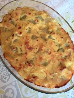 a cheesy casserole in a glass dish on a table