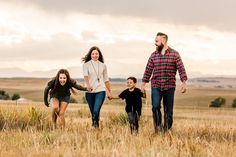 a family walking through a field holding hands