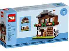 a lego box with a house made out of wood and flowers on the front window