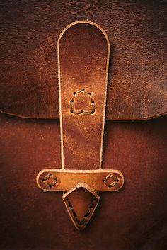 an old brown leather bag with the handle on it