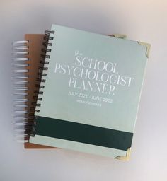 two spiral notebooks sitting on top of each other