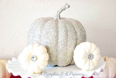 a white pumpkin sitting on top of a cake