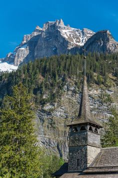 an old church with a steeple in the mountains