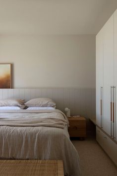 a bed sitting in a bedroom next to a dresser