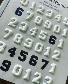 the numbers are made out of plastic and placed on top of a piece of paper