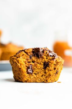 a close up of a muffin on a plate with other muffins in the background