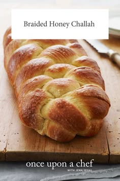 a loaf of bread sitting on top of a wooden cutting board