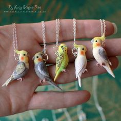 four small birds sitting on top of a person's hand