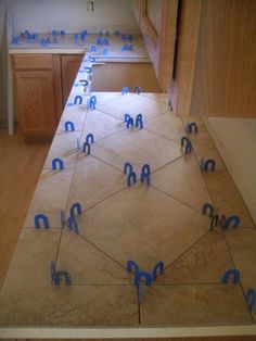 a kitchen counter with blue tape taped around the edges to make it look like hexagonal shapes