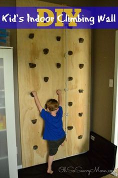 a young boy climbing on a rock wall with the words kids indoor climbing wall above him