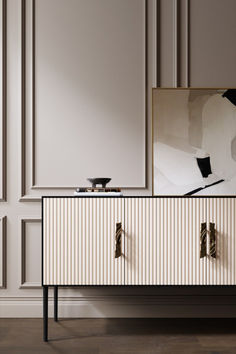 a white and black striped dresser with two doors on the front, one door open to reveal a mirror