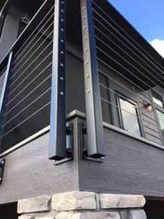 the corner of a building with metal railings on it's sides and windows