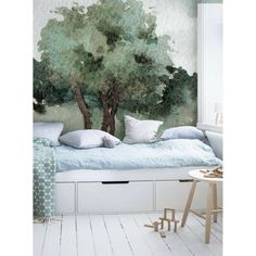 a bedroom with a tree mural on the wall