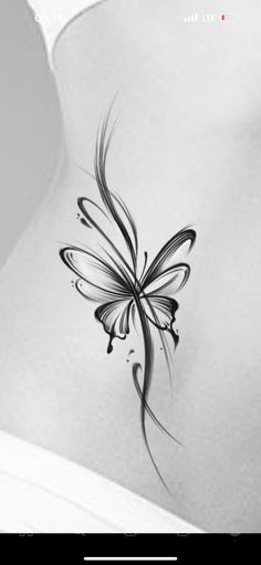 a black and white photo of a butterfly tattoo on the back of a woman's stomach