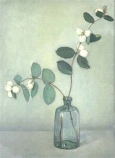 a glass vase filled with white flowers and green leaves