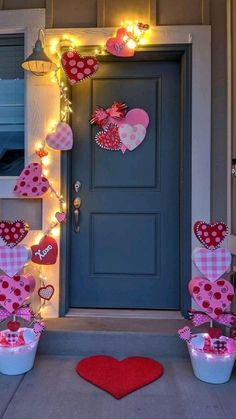 valentine's day decorations on the front door of a house with hearts and lights