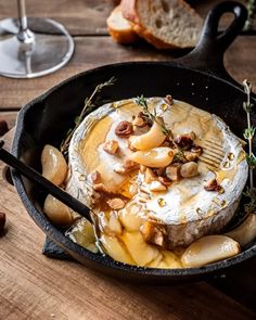 a skillet filled with food on top of a wooden table