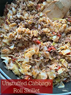 an uncooked cabbage roll skillet is shown with a wooden spoon in it