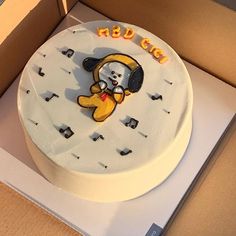 a birthday cake with a dog on it in a box