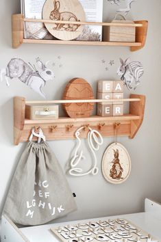 two wooden shelves with magnets and other items on them in a child's room