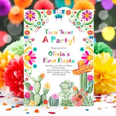 a mexican themed birthday party with colorful flowers and cactuses on the table, surrounded by confetti