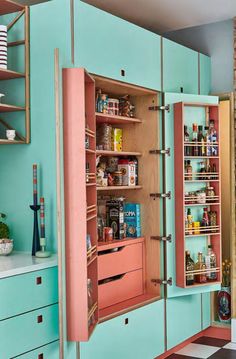 an open cabinet in the middle of a kitchen