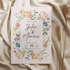 an image of wedding save the date card with flowers and leaves on it in front of a white background