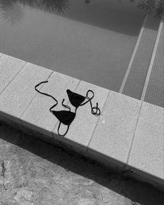 a black and white photo of a piece of artwork on the side of a building