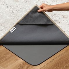 a person is holding onto a mat on the floor