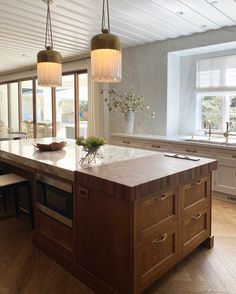 a kitchen island with two lights hanging over it