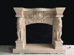 a white marble fireplace with carvings on it