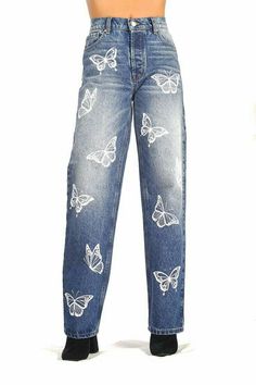 a woman in jeans with butterflies on them