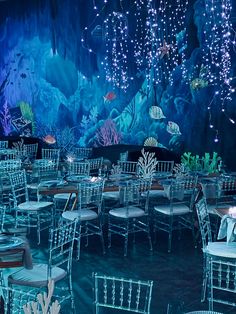 tables and chairs are set up in front of an underwater scene