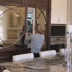 a woman standing in front of a kitchen counter