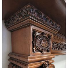 an ornate wooden shelf with carvings on it