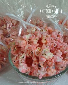 three bags of popcorn sitting next to each other on a white tablecloth covered table