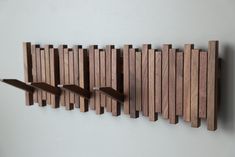 three wooden pieces are arranged on the wall