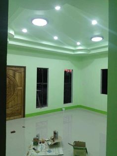 an empty room with green walls and white floors is being painted in the process of remodeling