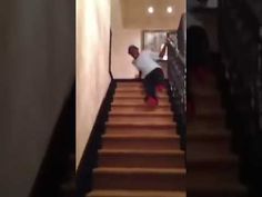 a man is climbing up the stairs in his house, and he's going down it