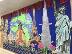 a wall with the statue of liberty and other landmarks painted on it, along with words around the world