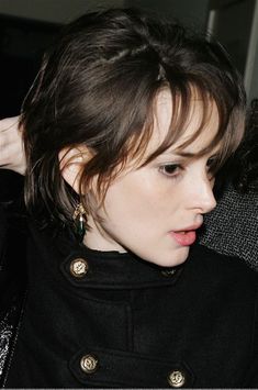 a close up of a person wearing a black coat