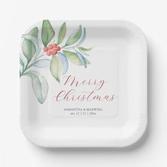 a paper plate with the words merry christmas written on it and watercolor holly leaves