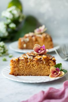 two plates with slices of cake on them and one slice has flowers in the middle