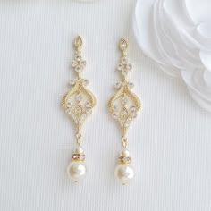 14K Yellow Gold Plated Vintage Inspired Bridal Earrings These vintage gold earrings are a seamless match with your vintage wedding styling. These vintage-style gold earrings are plated in 14K gold, the color of which is nither too dark not it is light. The earrings look delicate and lovely, made with sparkly cubic zirconia and available with pearl drops of cream or white color. You can also choose between round and teardrop pearl in the choice of pearl color. The length of the earrings 2.45 inch Pretty Jewellery Earrings, Vintage Bridal Earrings, Elegant Gold Earrings, Pearl Drop Earrings Bridal, Long Pearl Earrings, Vintage Gold Earrings, Bridal Jewelry Vintage, Vintage Earring, Gold Earrings Wedding