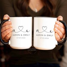 two people holding coffee mugs in their hands with the words love and an arrow on them