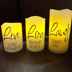 three lit candles with the words live, love, and every word written on them