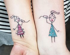 two people with matching tattoos on their arms and feet, one has a kite in the shape of a man and woman's head