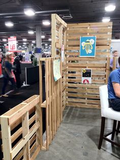 a person sitting on a chair in front of a booth