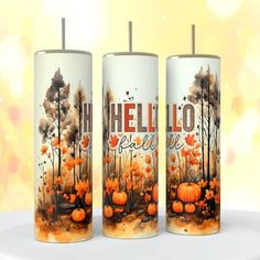 three candles with the words hello fall painted on them