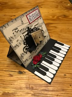 an accordion with music notes and a rose on it